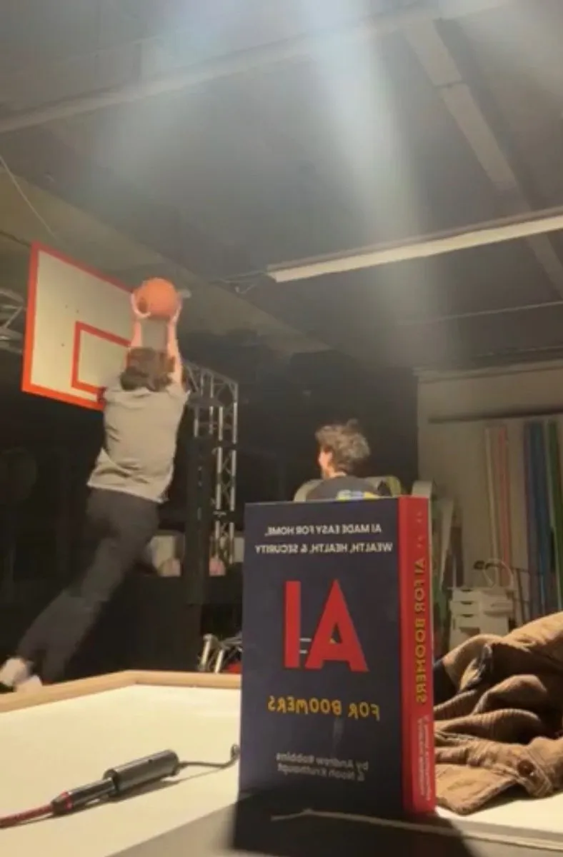 Shooting a basketball promo video with a copy of AI for Boomers in front